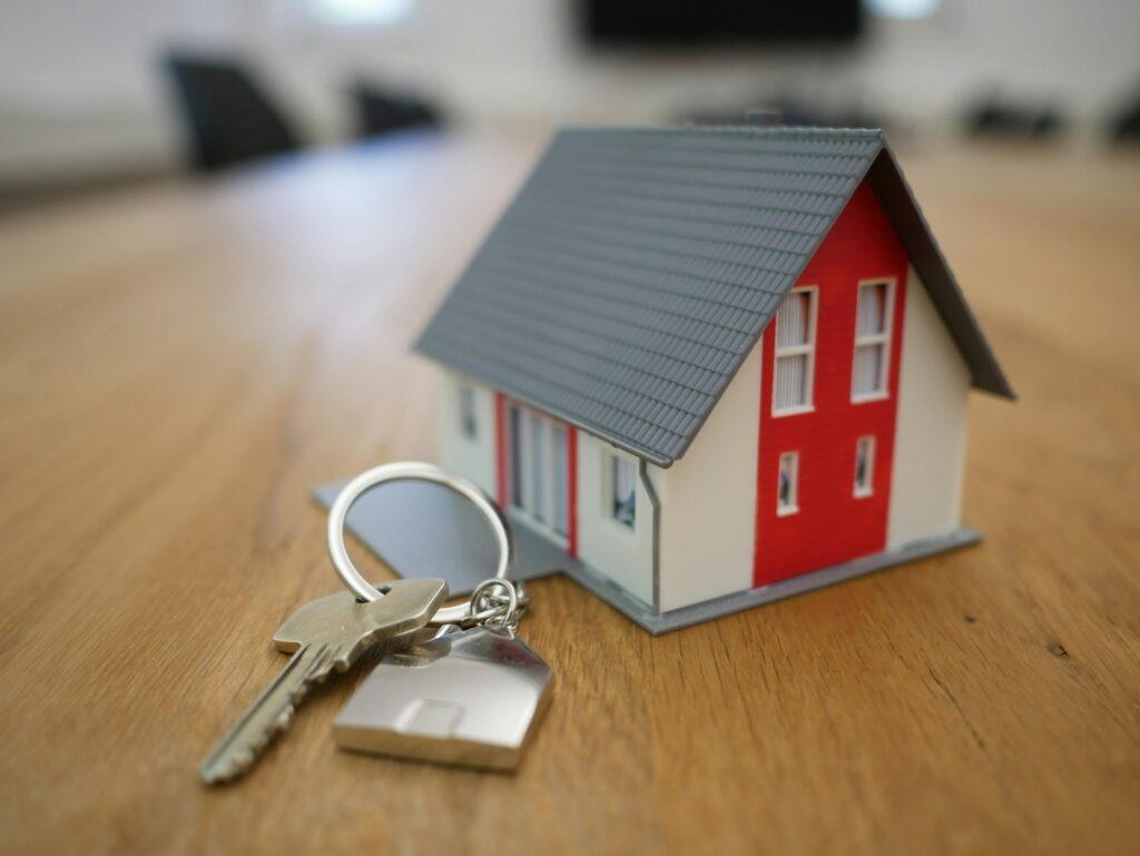 image of a model house on a table with a key next to it
