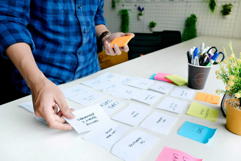 A man in a blue shirt arranging white printed paper